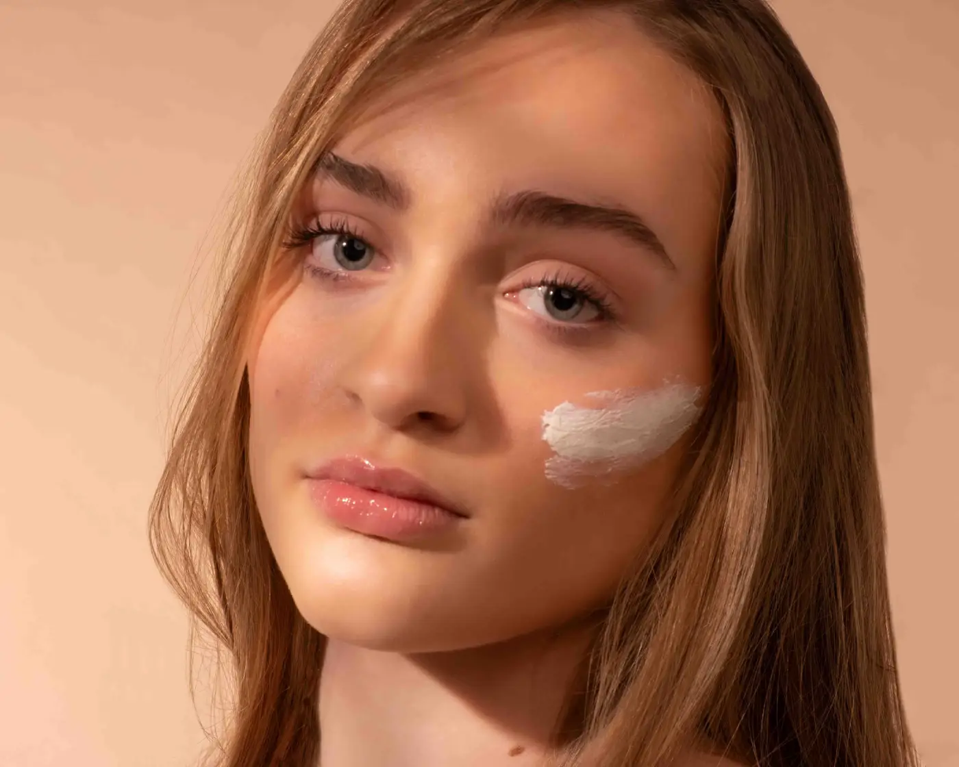 Girl with skin care product on face